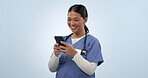 Happy asian woman, doctor and phone for communication or social media against a studio background. Female person, medical or healthcare nurse smile on mobile smartphone for research or networking