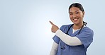 Healthcare, face and a woman or nurse pointing to mockup space for medical information. Happy, expert and portrait of a female surgeon with a gesture to a studio background for surgery announcement