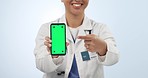 Woman, doctor and hands with phone green screen in advertising against a studio background. Closeup of female person, medical or healthcare surgeon pointing to mobile smartphone app display or mockup