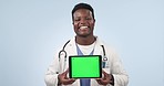 Black man, doctor and tablet with green screen in advertising against a studio background. Portrait of happy African male person or medical healthcare surgeon showing technology app display or mockup