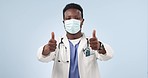 Face mask, doctor and black man with thumbs up, feedback and healthcare on a blue studio background. Portrait, African person or medical professional with hand gesture, promotion and review with like