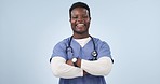 Crossed arms, doctor and face of black man in studio for medical service, care and support for hospital. Healthcare, professional and portrait of person on blue background for medicine and wellness 