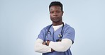 Crossed arms, doctor and face of black man in studio for medical service, care and support for hospital. Healthcare, professional and portrait of person on blue background for medicine or wellness