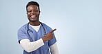 Nurse, advertising and black man pointing to mockup in studio isolated on a blue background. Portrait, hand and medical worker marketing healthcare, wellness promotion and smile for commercial space