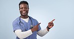 Happy black man, doctor and pointing to mockup in advertising or marketing against a studio background. Portrait of African male person, medical or healthcare nurse showing information, tips or deal