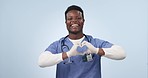 Heart in hands, doctor and black man in studio for medical service, care and support for hospital. Healthcare, emoji and portrait of person with love hand gesture for insurance on blue background