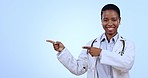 Pointing, smile and face of woman doctor in studio with mockup for advertising or marketing. Happy, mock up and portrait of African female healthcare worker with show hand gesture by blue background.