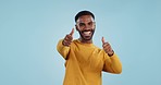 Happy, face and man with thumbs up in studio for support, motivation or vote on blue background. smile, portrait and excited male model with hand emoji for winning, thank you or success gesture