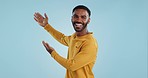 Happy, face and man with hand pointing in studio for news, presentation or platform offer on blue background. Smile, portrait and male model show promo, launch or space for coming soon announcement