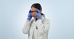 Frustrated, scientist and anxiety from thinking of mistake, fail or problem in lab on blue background in studio. Woman, stress and hands on head in science laboratory with depression or burnout