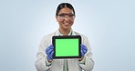 Happy asian woman, tablet and scientist with green screen in advertising against a studio background. Portrait of female person medical professional smile showing technology display, app or mockup