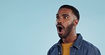 Black man, surprise announcement and shock on face, expression and drama on blue background. Wow, reaction to news and alarm in studio with gossip, alert and mockup space with mind blown in studio