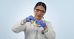 Studio, Asian woman or scientist with solution in glass for lab test in chemistry, biotech or medical research. Chemical study, vaccine development and science, doctor with liquid on blue background.