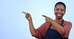 Happy, pointing and black woman or waitress on mockup for advertising or information. Smile, face portrait and an African person or restaurant employee with a gesture to space on a blue background