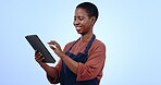 Waitress, woman and business owner on tablet for cafe management, online inventory or e commerce in studio. African entrepreneur or restaurant worker typing, digital technology and a blue background