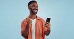 Man, fist celebration and phone in studio for esports, gambling and profit with trading by blue background. African person, investor and smartphone with fintech app, lotto and revenue on stock market