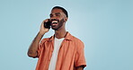 Phone call, funny and black man talking, conversation and joke in studio isolated on a blue background mockup space. Smartphone, laughing and happy African person in communication, meme and comedy