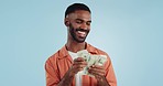 Man, count money and happy in studio with success, bonus or promotion with winning by blue background. Investor, trader or person with cash, salary or savings with smile for financial freedom goal