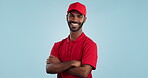 Delivery man, arms crossed in portrait and e commerce, distribution with supplier and service on blue background. Professional, supply chain and logistics worker for shipping and courier in studio