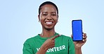 Woman, volunteering and phone green screen, presentation mockup and support, join us or marketing in studio. Face of African person on mobile app or pointing to information for NGO on blue background