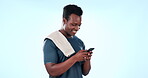 Happy man, fitness and phone for workout communication, social media update or progress information in studio. African athlete with sports chat, mobile networking and funny meme on a blue background