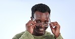 Glasses, laughing and black man face with a smile and happy from lens and frame choice. Studio, blue background and African male person with flirty gesture and eyeglasses decision with portrait