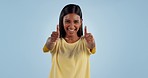 Happy woman, dancing and thumbs up in success, good job or winning against a blue studio background. Portrait of excited female person showing like emoji, yes sign or OK for positive mindset or agree