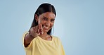 Woman, face and pointing to you in studio for choice, decision of winner or vote for volunteering on blue background. Portrait, happy indian model and wink for recruitment, hiring emoji or invitation