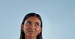 Thinking, happy and woman with mockup space for idea and inspiration in studio. Blue background, female person and gen z model with smile from contemplation, question and problem solving of student