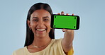 Happy woman, phone and green screen for advertising, marketing or branding against a studio background. Portrait of female person showing mobile smartphone app display or mockup with tracking markers