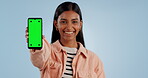 Happy woman, phone and green screen with mockup for advertising or marketing against a studio background. Portrait of female person smile showing mobile smartphone app, display or tracking markers