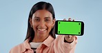 Happy woman, phone and green screen for advertising, software or marketing against a studio background. Portrait of female person showing mobile smartphone app display or mockup with tracking markers