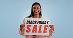 Happy woman, billboard and Black Friday sale for discount, price or shopping deal against a studio background. Portrait of female person with poster sign for advertising, special or retail marketing