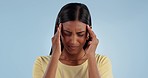 Stress, headache and Indian woman in studio with pain, inflammation and fatigue with anxiety. Mental health, burnout and person with head pain, migraine and problem for crisis on blue background