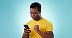 Phone, angry or annoyed with a frustrated black man in studio on a blue background for communication. Mobile, breathing and stress with the reaction of a young person reading a bad news text message