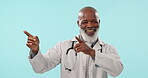 Doctor, smile and mature black man point at medical sales, hospital announcement or advertising promotion. Studio ads direction, nurse notification or portrait surgeon presentation on blue background