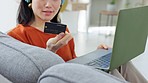 Ecommerce, credit card payment and woman with laptop for internet purchase in modern apartment home in Tokyo Japan. Asian girl, iot fintech and online shopping for digital retail store on 5g network 