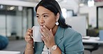 Coffee, office and business woman by her desk with mug drinking a warm beverage in the morning. Happy, calm and professional Asian female employee enjoying cup of caffeine while working in workplace.