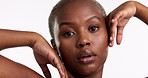 Beauty, pose and hands on face of black woman in studio for skincare, wellness or cosmetics on white background. Hand, portrait and serious girl model with glowing skin, satisfaction and results