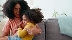 Hug, happy and mother with daughter on a sofa, laughing and playing in their home together. Laugh, love and parent with girl on a couch, bonding and having fun with game, playful and relax on weekend