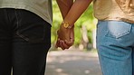 Back of couple holding hands in park for love, date and relax for commitment to life partner in garden. Closeup of man, woman and helping hand in nature for hope, loyalty and care of support together