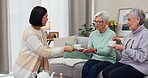 Friends, tea and women visit in home for conversation, discussion and talking for social gathering. Happy, living room and female people on sofa with drink for bonding, quality time or relax together