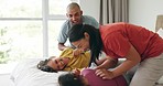 Bed, laughing and parents tickle kids, bonding or enjoy quality time together, vacation holiday and play games. Morning happiness, funny and home mom, dad and children having fun on bedroom mattress