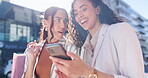 Happy woman, phone and friends laughing in city for funny joke, social media or post after outdoor shopping. Women smile together on mobile smartphone for online browsing, retail or research in town