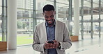 Happy businessman, phone and walking at office in social media, communication or networking. Black man or employee texting or chatting online on mobile smartphone app in building at the workplace