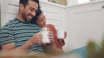 Couple relax on floor of kitchen with coffee, smile and embrace together, talking and bonding in home. Happiness, man and woman with hot drink, love and conversation in apartment, planning with tea.