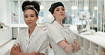 Team, chef and women with arms crossed in kitchen at restaurant for hotel service. Portrait, cooking and collaboration with culinary professional and employee for catering career or competition