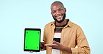 Tablet, green screen and a man in studio with mockup website, internet and social network. Happy black person with technology tracking markers, advertising or app announcement on blue background