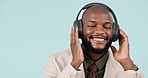 Dancing, business man and headphones in studio with internet, energy and app. Happy, face and African person from Kenya on a blue background listening or streaming music with online subscription