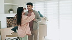 Couple, dancing and excited to celebrate new home or moving in together with real estate property. Happy man and woman dancer with fun energy in their first house with mortgage, boxes and investment 